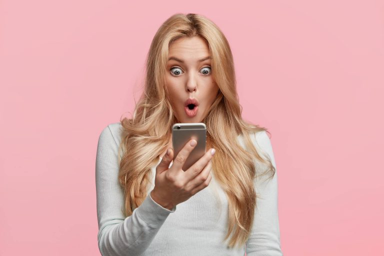 A bride looking at an invitation on her mobile phone