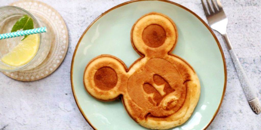 A mickey mouse shaped disney pancake on a plate for a hen party breakfast