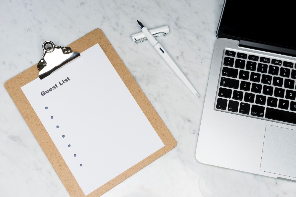 A wedding guest list on a clipboard being used for an irish wedding