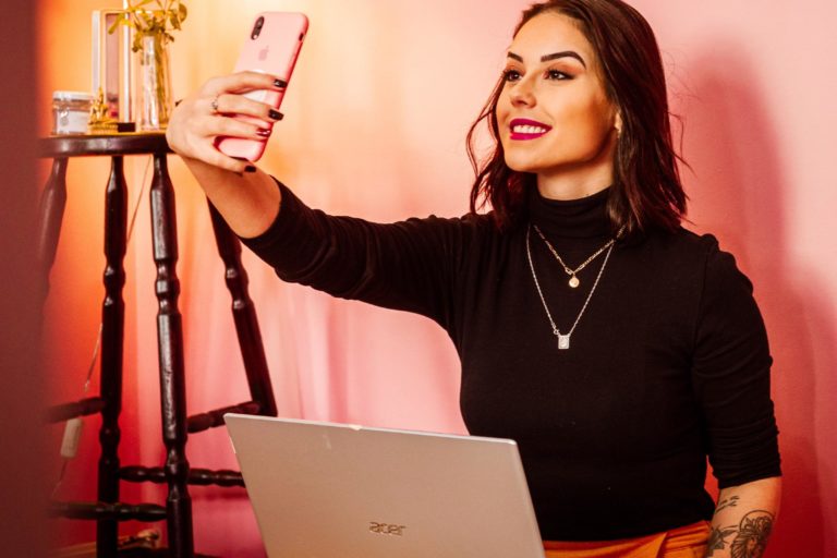 A woman at home on her phone for a virtual hen party