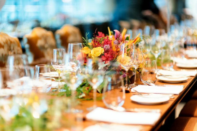 A wedding table with floral arrangements and place settings