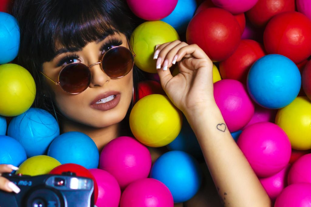 woman surrounded by coloured balls for hen party bingo game