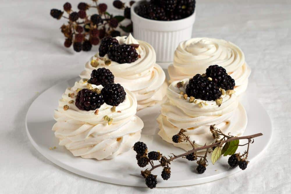 Black and white hen party food with meringues and blackberries