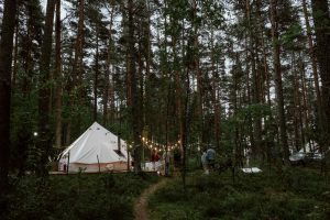 A glamping hen party site in the woods with fairy lights