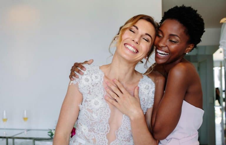 A bride and bridesmaid who has done her bridesmaid duties well