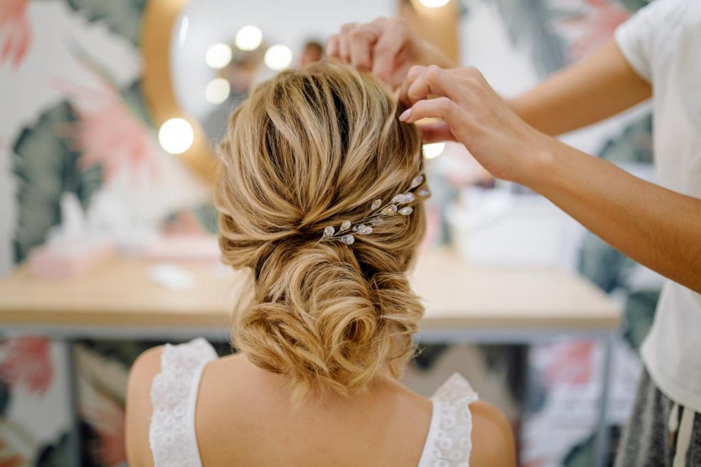 Bridesmaid duties watching over the bride's hair and makeup