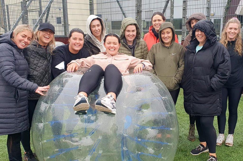 Girls doing bubble football for a hen party after covid