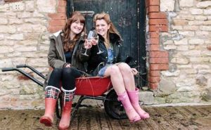 Two girls taking part in the farmer's bride hen party activity
