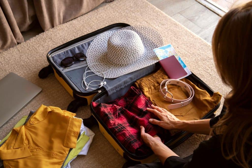 A young woman with a suitcase making sure she has everything from her hen party packing list