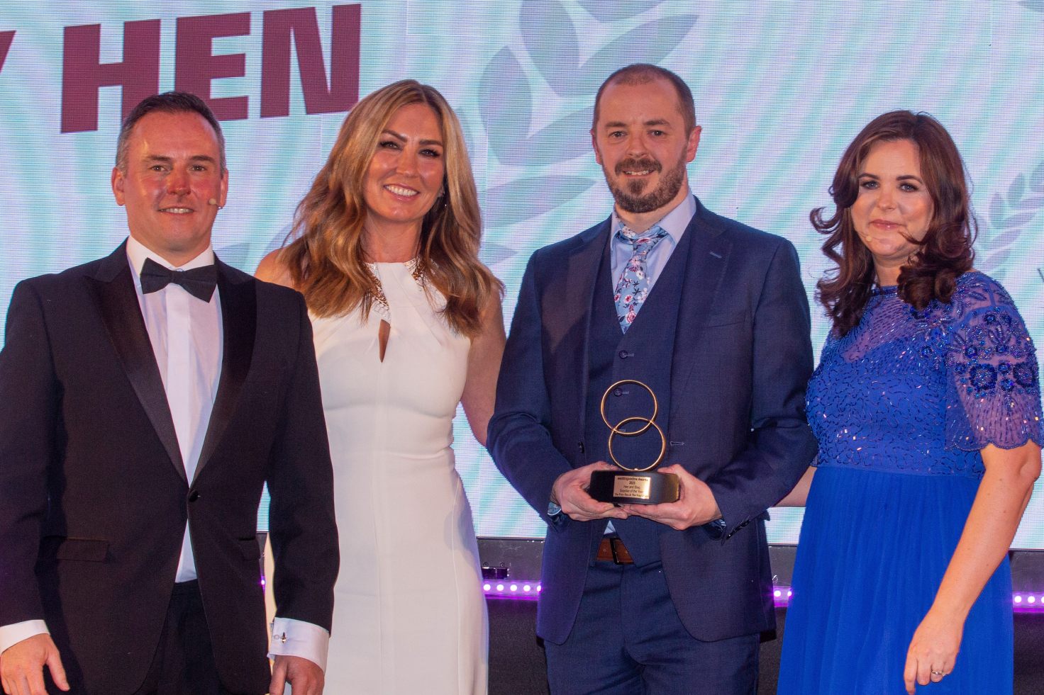 The Foxy Hen team on stage at the awards receiving their trophy for best hen party supplier 2023