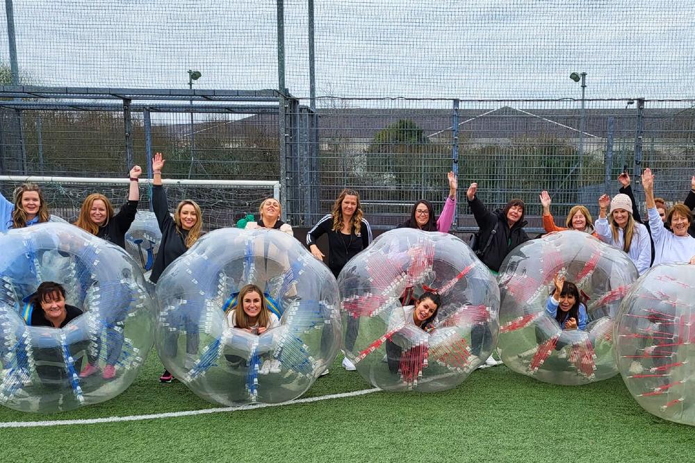 A hen party group posing after a game of bubble football for their hen activity