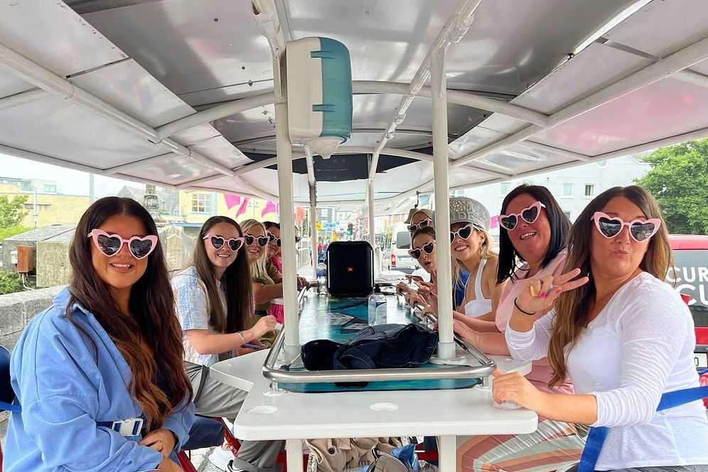 A small group of girls on a pedal bus for a pedal pub tour in Galway