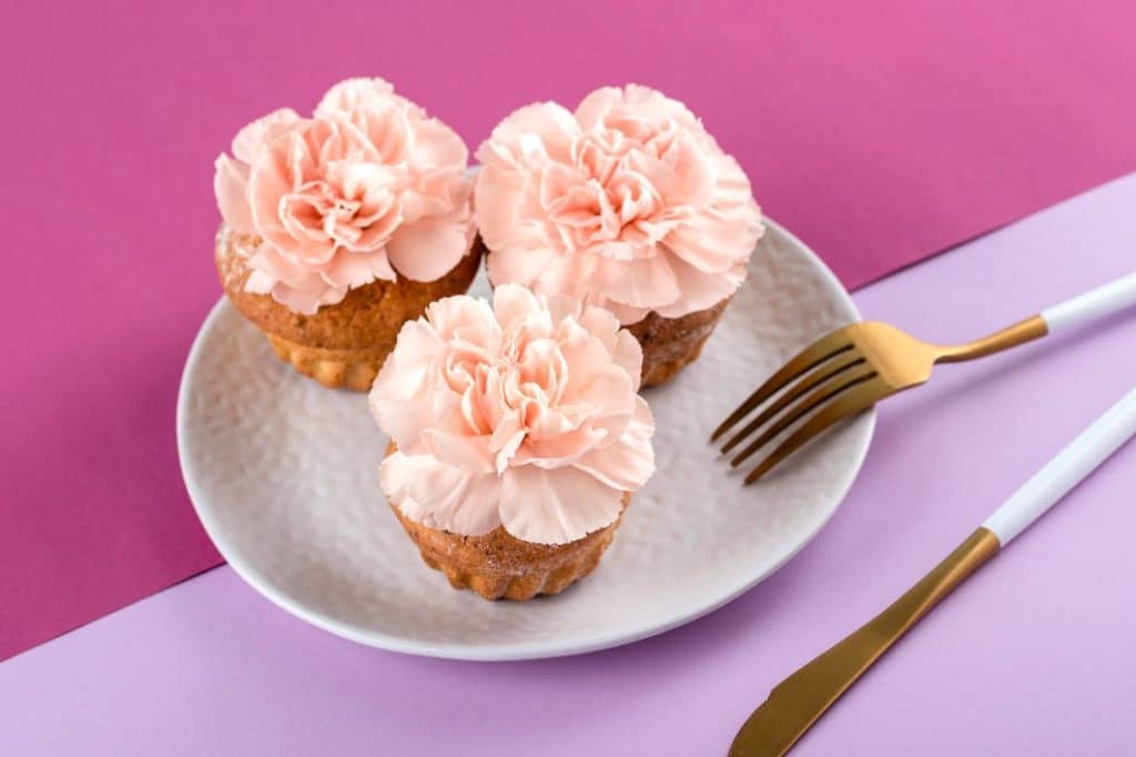 Three flower covered cupcakes for a floral hen party theme
