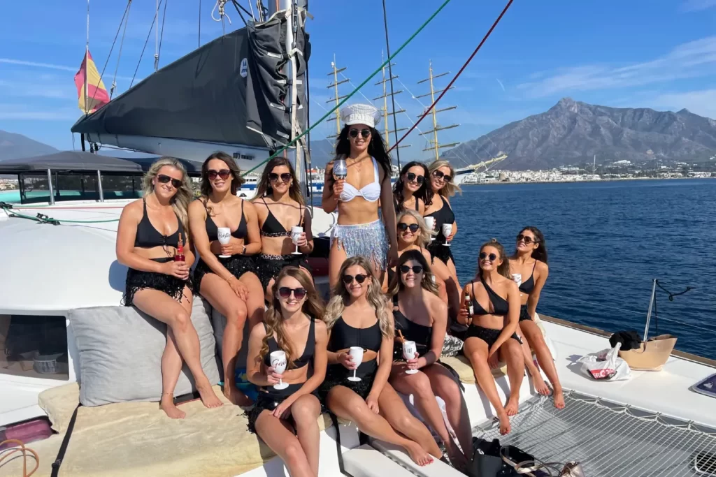 A group on a hen party catamaran for their activities in Marbella in Spain