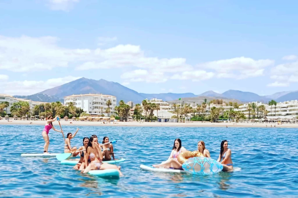 A group of women on a hen party in Marbella in Spain doing their paddle boarding activities